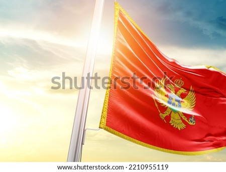 Montenegro national flag cloth fabric waving on the sky with beautiful sunlight - Image