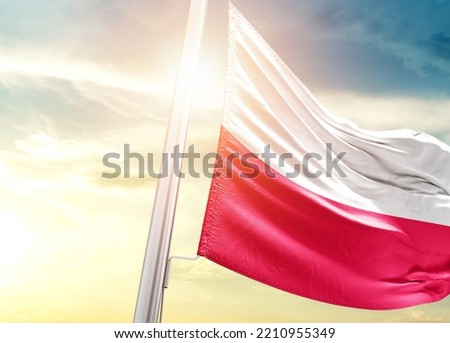 Poland national flag cloth fabric waving on the sky with beautiful sunlight - Image