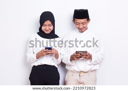 asian muslim couple using smart phone isolated on white background