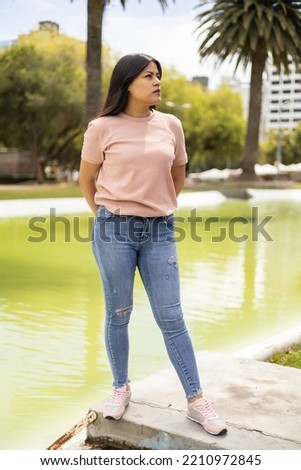 nature and young latin woman with straight black hair wearing casual clothes, youth beauty and fashion, beautiful model