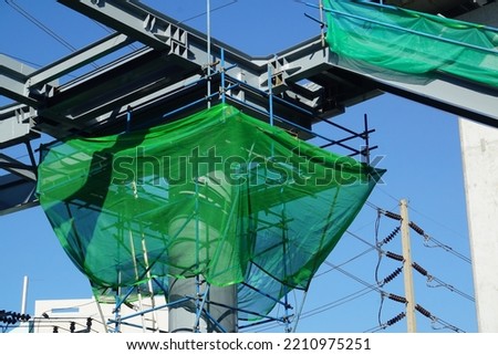 Shading Net was used for temporary wall around construction site.Green Shading Net and green metal sheet fence prevents dust from construction site.												