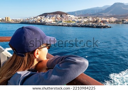 Woman enjoying the panoramic view from the ferry on the port of San Sebastian de La Gomera, La Gomera and Tenerife, Canary Islands, Spain, Europe. Spring and summer. Island hopping vacation Royalty-Free Stock Photo #2210984225