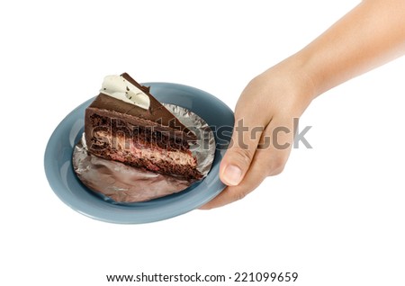 Image of chocolate cake in ceramic dish with hand on white background