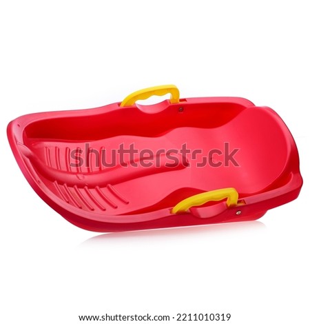 Children's plastic Red sled isolated on a white background. Sleds for skiing downhill in winter. Children's toys. Slide board.