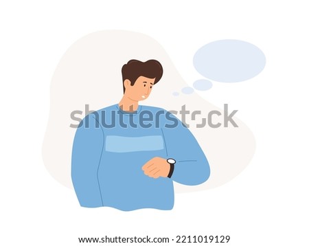 The man looks at his watch in anticipation Royalty-Free Stock Photo #2211019129