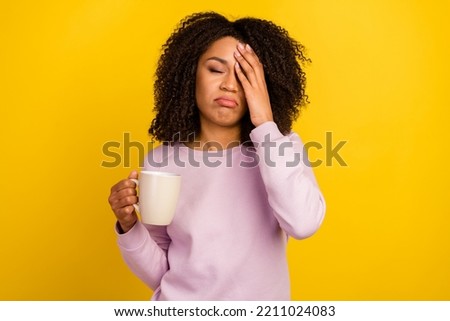 Photo of young exhausted woman hand touch face drink espresso latte isolated over yellow color background.