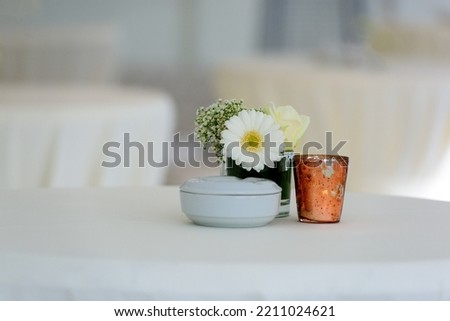 White flower on a table whit a white napkin and a lot of copy space Royalty-Free Stock Photo #2211024621