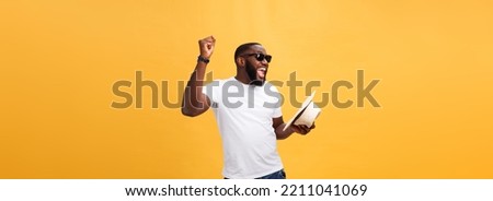 Young black man top dancing isolated on a yellow background.