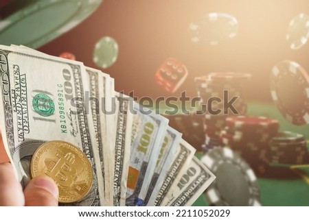 Classic playing cards, chips, red dice, bitcoin and dollars on green background. Gambling and casino concept. Royalty-Free Stock Photo #2211052029
