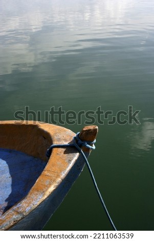 fishing boat moored by the lake