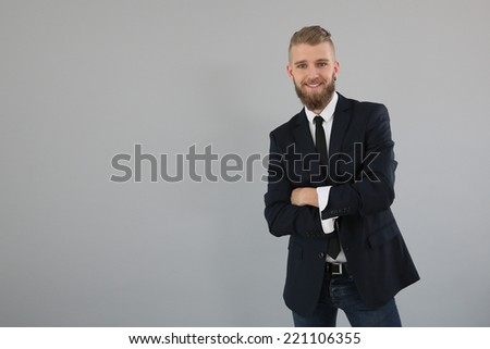 Businessman with arms crossed on grey background