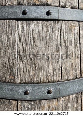 Gray wooden barrel with metal clamps
