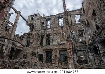 destroyed and burned houses in the city Russia Ukraine war Royalty-Free Stock Photo #2211084957