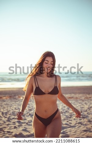 Joyful young woman having fun and relaxing on summer vacation at the beach.