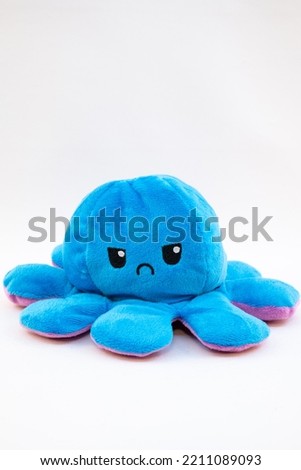 A plushy octopus with two diffrent sides. Royalty-Free Stock Photo #2211089093