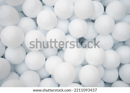 Many white plastic balls for dry pool in amusement park Royalty-Free Stock Photo #2211093437