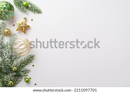Christmas decorations concept. Top view photo of gold and green baubles transparent ball star ornament confetti and pine branches in snow on isolated white background with empty space