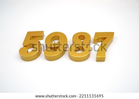   Number 5987 is made of gold-painted teak, 1 centimeter thick, placed on a white background to visualize it in 3D.                                