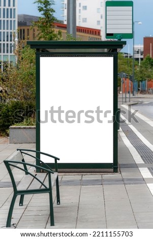 A vertical shot of a blank billboard on a bus stop in the city center with copy space