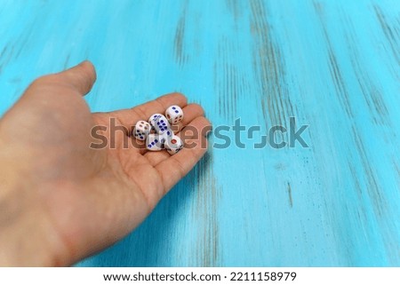 Dice on the blue wooden playing field. Concept of online gambling, winner or player.