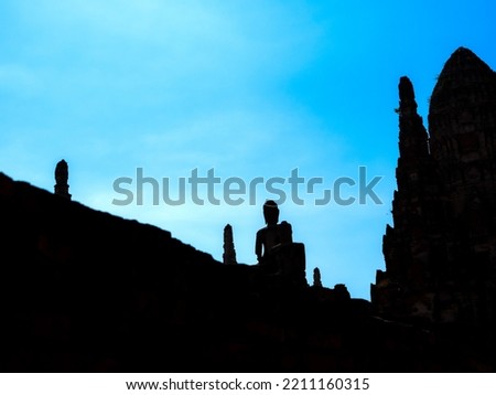 The Silhouette Ancient Buddha Statue and Temple behind The Blue Background in Ayutthaya