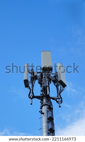 Telecommunication tower of 4G and 5G cellular. Macro Base Station. 5G radio network telecommunication equipment with radio modules and smart antennas mounted on a metal on cloulds sky background. Royalty-Free Stock Photo #2211166973