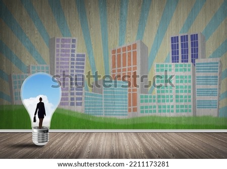 Businesswoman inside light bulb against city drawn concept