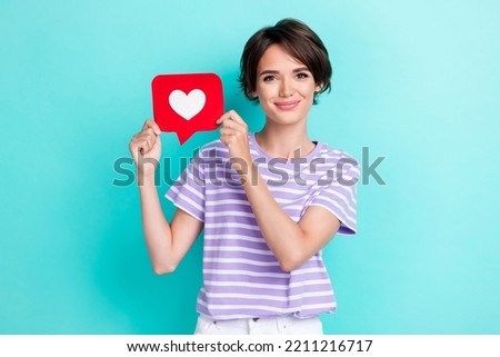Photo of adorable nice cute stylish woman dressed striped t-shirt get like in social media isolated on turquoise color background