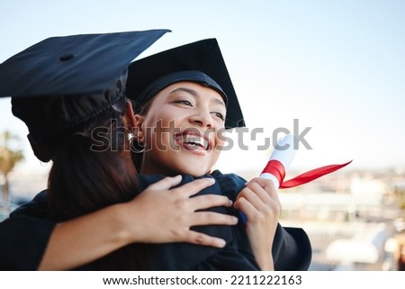 Graduation, education and hug with woman student friends hugging on university campus in celebration of success or qualification. College, graduate and scholarship with a female and friend embracing Royalty-Free Stock Photo #2211222163