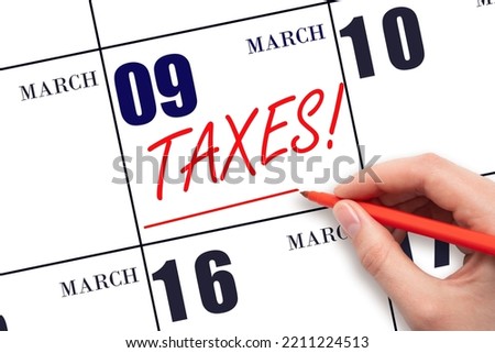 9th day of March. Hand drawing red line and writing the text Taxes on calendar date March 9. Remind date of tax payment. Tax day concept. Spring month, day of the year concept.