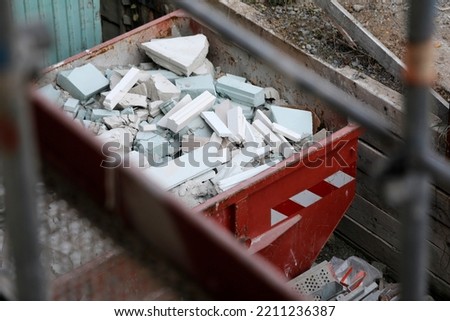 Container with rubble on construction site.