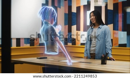 An avatar of a girl gives presentation to an asian woman through an abstract hologram screen in metaverse. Technology of digital world in parallel with the physical one. Augmented Reality.