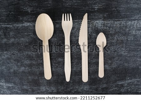 wooden serving pieces isolated on wooden black background flat lay. Image contains copy space