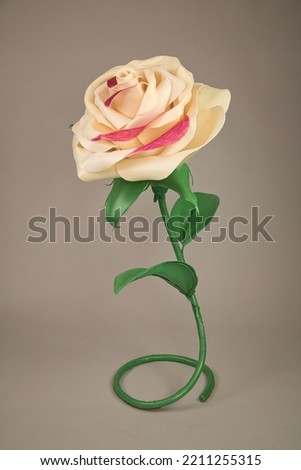 White natural color handmade rose on a light brown background.