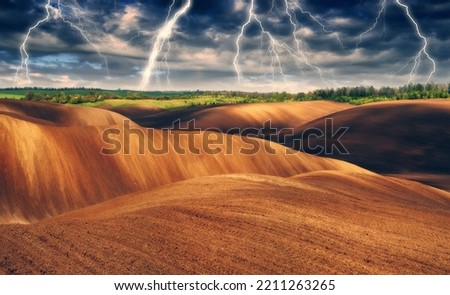 lightning over a hilly field. landscape with dramatic thunderclouds in the background. nature of Ukraine