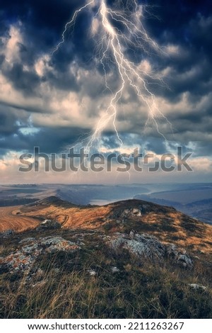 lightning over a hilly field. landscape with dramatic thunderclouds in the background. nature of Ukraine