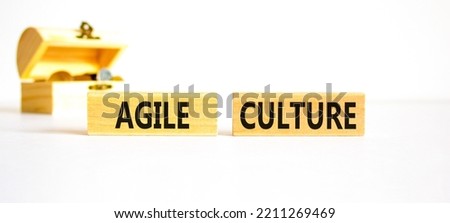 Agile culture symbol. Concept words Agile culture on wooden blocks. Beautiful white table white background. Wooden chest with coins. Business flexible and agile culture concept. Copy space.