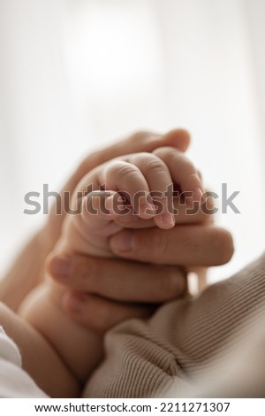 New born baby hand hold mum index finger. Mother and baby. Royalty-Free Stock Photo #2211271307