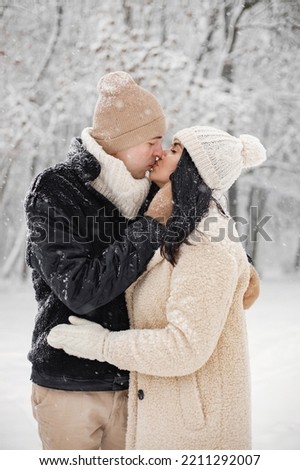 Portrait of romantic couple walking in forest at winter day