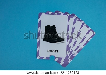 Flashcard with a picture of a black bot placed on a blue background.