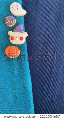 Halloween theme cookies on a cloth background.
