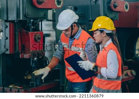 engineer male training and check machine with woman worker team in metal industry factory