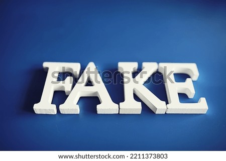 The letters spelled the word fake. The concept of modern information technology. Fake and facts in news.