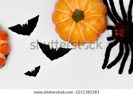 Halloween decorations concept, Scary smiling pumpkin and spider with silhouette of flying black bat.