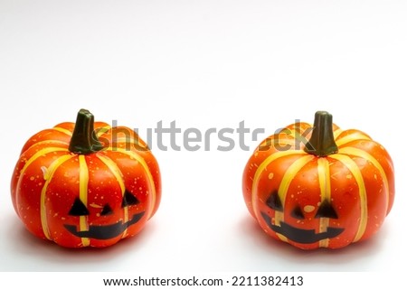 Halloween decorations concept, Two scary smiling pumpkins on white background.
