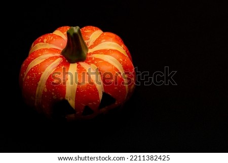 Halloween decorations concept, Scary smiling pumpkin on black background.