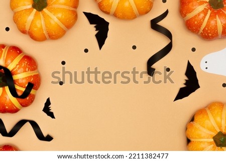 Halloween symbol concept, Scary smile pumpkins and ghost with black bat on cream background.