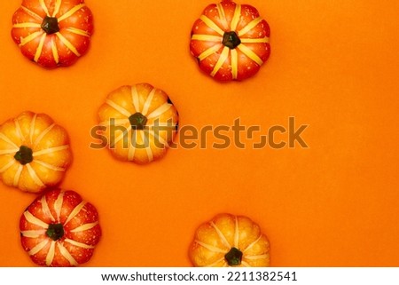 Halloween decorations concept, Top view of scary smiling pumpkins on orange background.