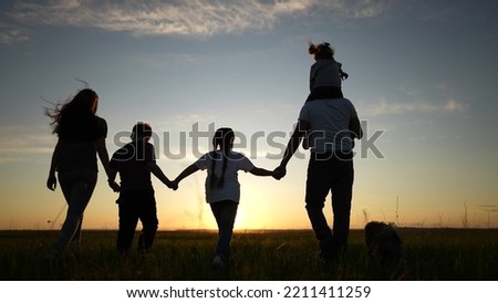 people in the park silhouette. happy family kid dream holiday concept. friendly family holding hands walking dog at sunset in the park lifestyle silhouette. big family silhouette walk in the park