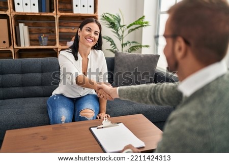Man and woman psychology and patient having psychologist session shake hands at psychology clinic Royalty-Free Stock Photo #2211424313